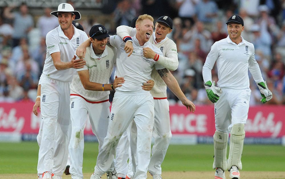 England’s Ben Stokes, celebrates with teammates after bowling Australia’s Mitchell Johnson caught by Alastair Cook for 5 runs during day two of the fourth Ashes Test cricket match, at Trent Bridge, Nottingham, England.