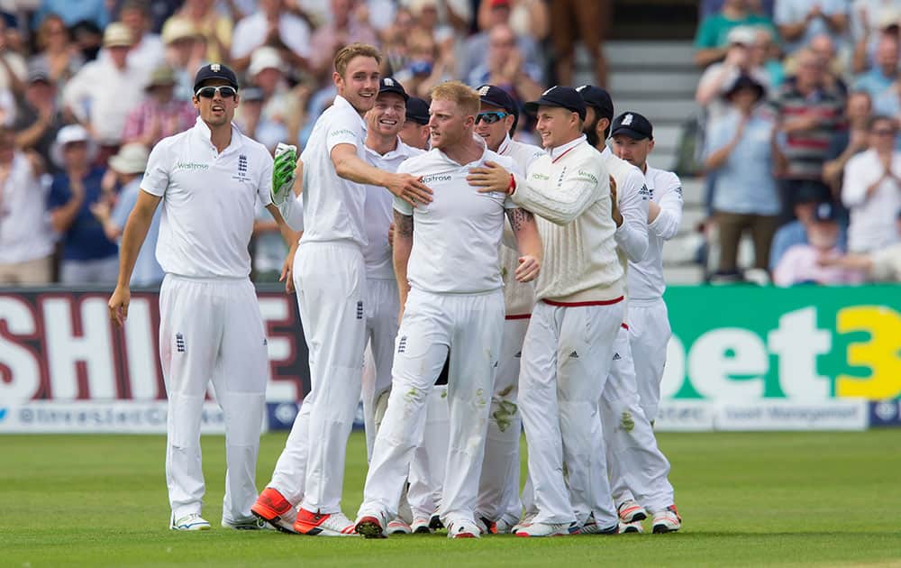England's Stuart Broad, celebrates with teammates after taking the wicket of Australia's Steven Smith, caught by Ben Stokes, centre, for 5 on the second day of the fourth Ashes test cricket match between England and Australia at Trent Bridge cricket ground in Nottingham, England.