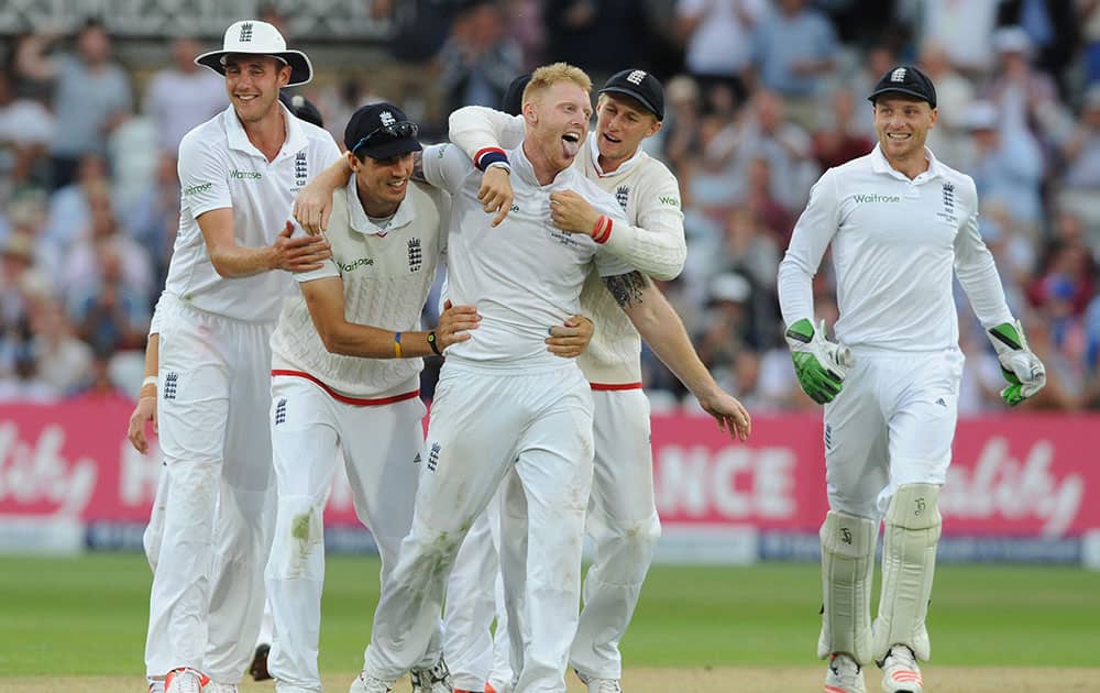 England’s Ben Stokes, centre, celebrates with team mates after bowling Australia’s Mitchell Johnson caught Alastair Cook for 5 runs during day two of the fourth Ashes Test cricket match, at Trent Bridge, Nottingham.
