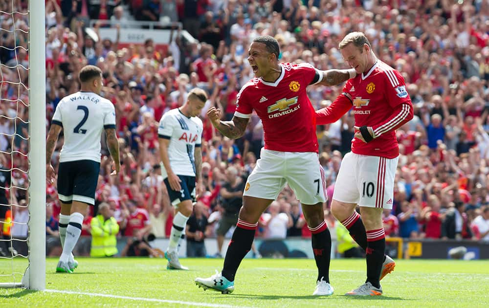 Manchester United's Wayne Rooney, right, celebrates with teammate Memphis Depay after an own goal by Tottenham's Kyle Walker, right, during the English Premier League soccer match between Manchester United and Tottenham at Old Trafford Stadium, Manchester.