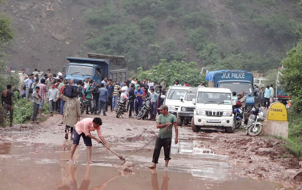 The slush and mud being cleared from the Jammu-Srinagar National Highway after landslides triggered by heavy rains in Udhampur.
