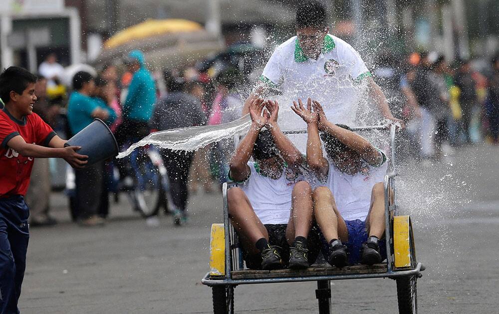 A youth throws water on porters, known as 