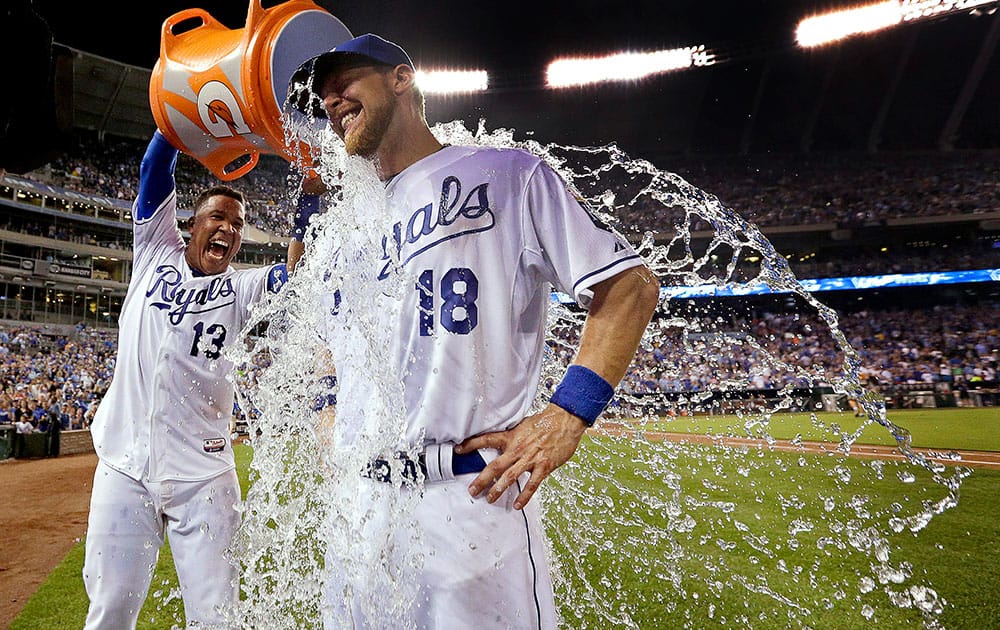 Kansas City Royals' Ben Zobrist (18) is doused by Salvador Perez after a baseball game against the Chicago White Sox in Kansas City, Mo.