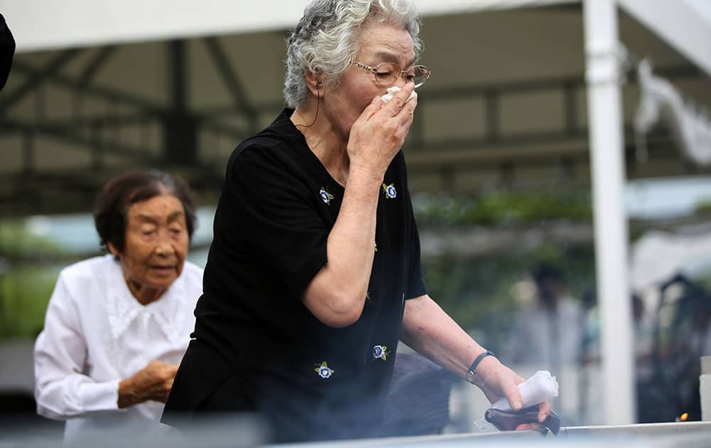 A woman cries as she offers prayers at the Peace Park before the 70th anniversary of the Nagasaki atomic bombing in Nagasaki.