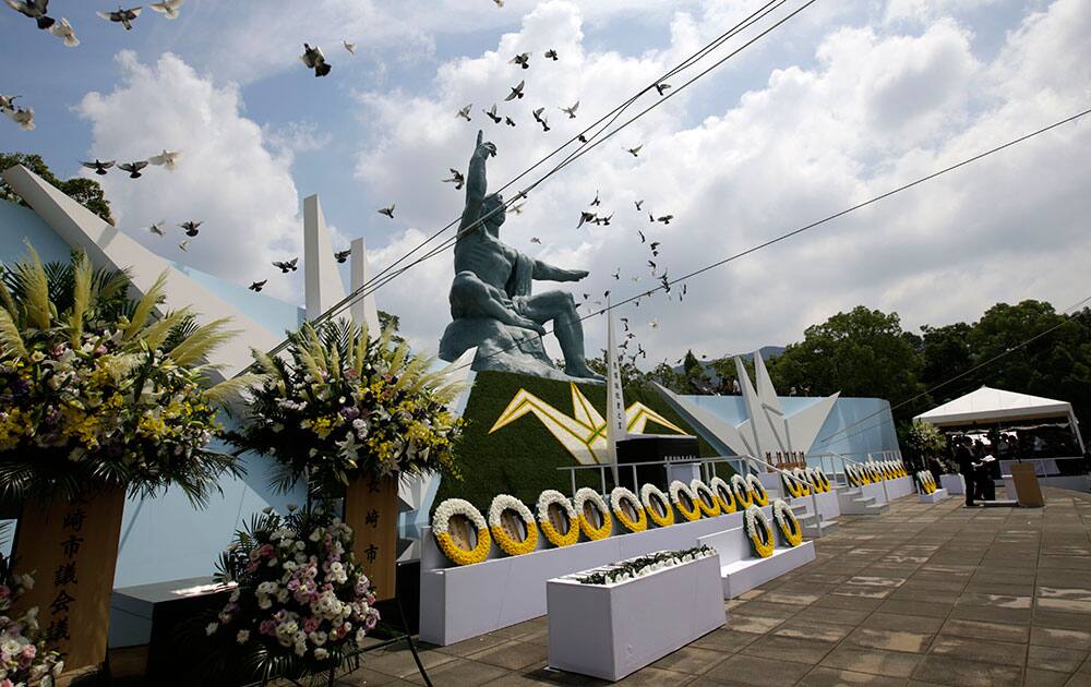 Doves fly over the Peace Statue during a ceremony to mark the 70th anniversary of the atomic bombing in Nagasaki.