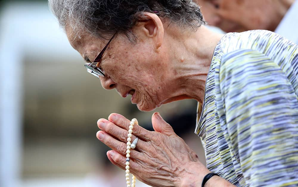 A woman cries as she offers prayers at the Peace Park before the 70th anniversary of the Nagasaki atomic bombing in Nagasaki.