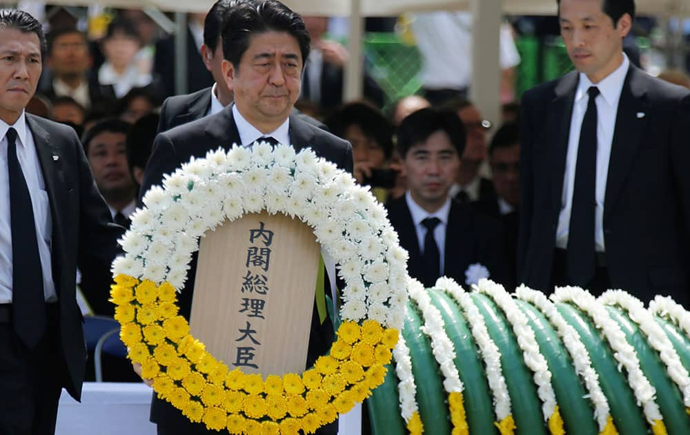 Japanese Prime Minister Shinzo Abe holds a wreath during a ceremony to mark the 70th anniversary of the Nagasaki atomic bombing in Nagasaki.