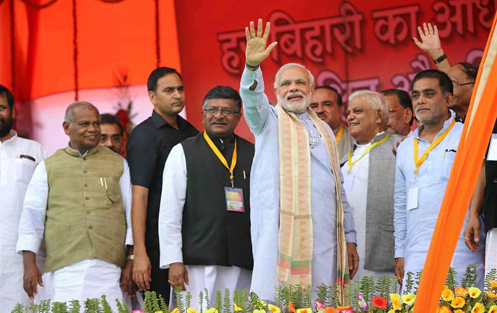 Prime Minister Narendra Modi waves to his supporters during the Parivartan rally at Gandhi Maidan, in Gaya.