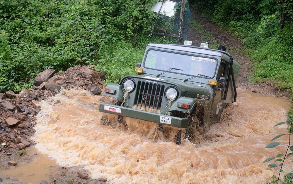 A participant drives his Jeep through a rivulet during 4X4 Nature Riders 2K 15 Rally at Belthangady, near Mangaluru.