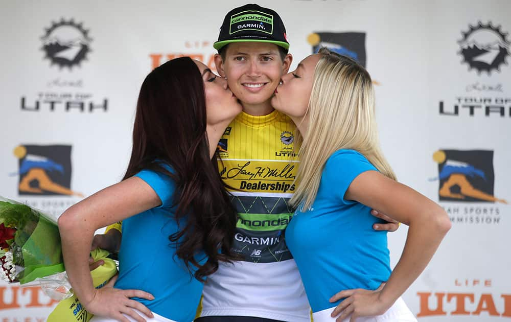 Tour of Utah overall winner Joe Dombrowski receives a kiss on the podium following the tour of Utah.