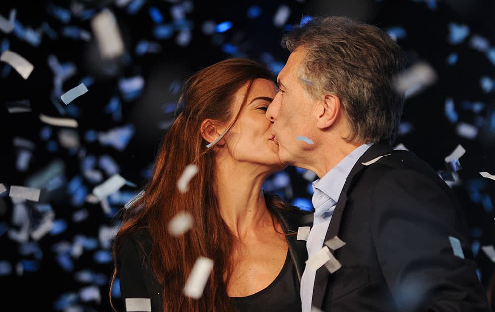 Outgoing mayor of Buenos Aires and top opposition presidential candidate Mauricio Macri , right, kisses his wife Juliana Awada after the primary elections in Buenos Aires, Argentina.