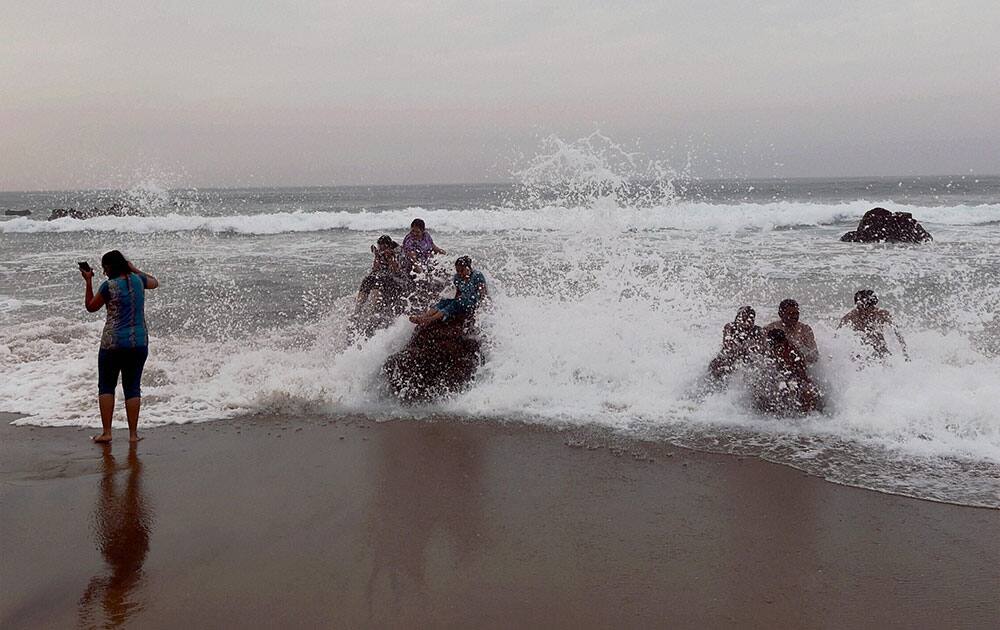 Tourists enjoying bathing at Varun beach in Visakhapatnam.