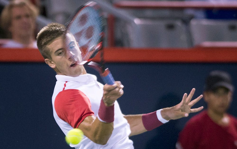 Borna Coric, of Croatia, returns to Jo-Wilfried Tsonga, from France, during their first round match at the Rogers Cup tennis tournament in Montreal.