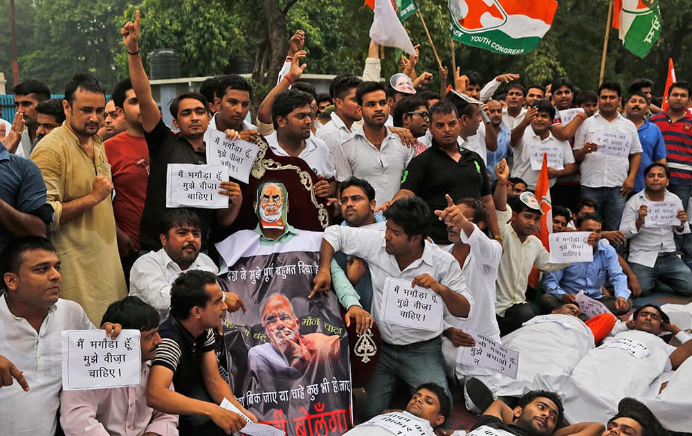 Congress party’s youth wing activists shout slogans demanding the resignation of three key ruling party leaders accused of abusing their authority and financial irregularities during a protest near the Indian Parliament in New Delhi.