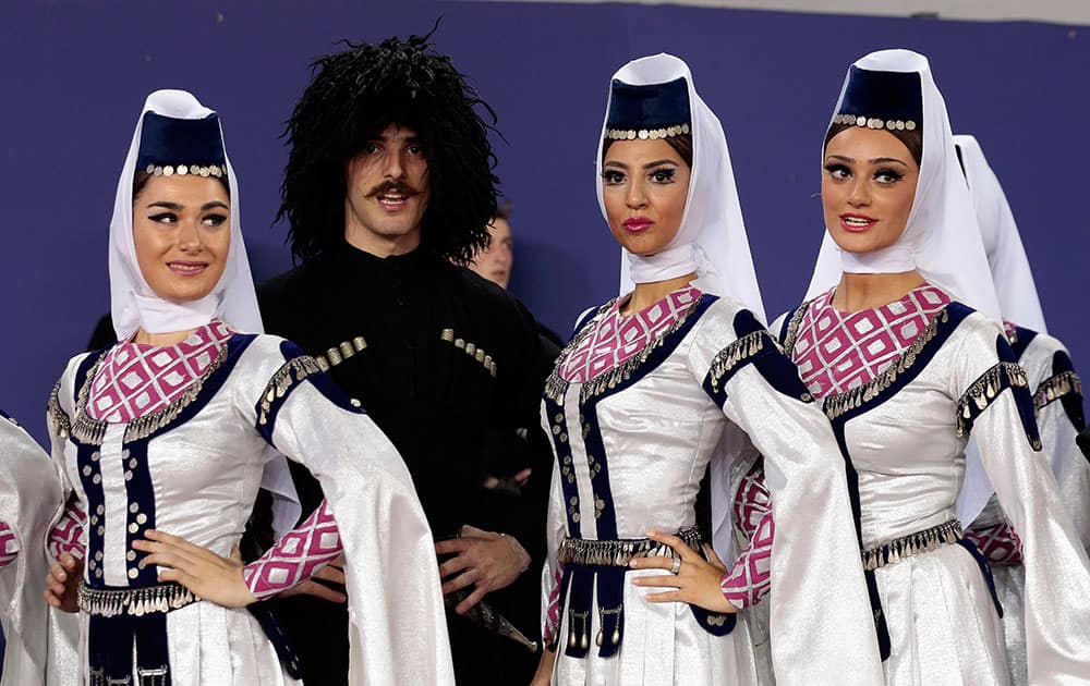 Performers wait to participate in a ceremony before the UEFA Super Cup soccer match between FC Barcelona and Sevilla FC at the Boris Paichadze Dinamo Arena stadium, in Tbilisi, Georgia.