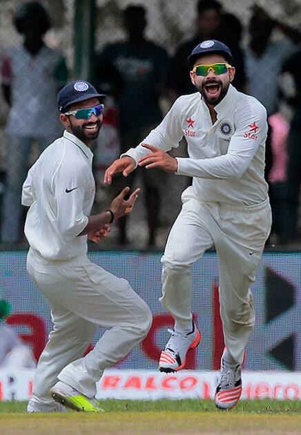 Virat Kohli, celebrates with teammate Ajinkya Rahane the dismissal of Sri Lanka’s Kaushal Silva during their first cricket test match in Galle, Sri Lanka.