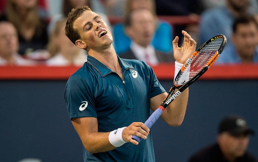 Canada's Vasek Pospisil reacts during his match against John Isner, of the United States, at the Rogers Cup tennis tournament