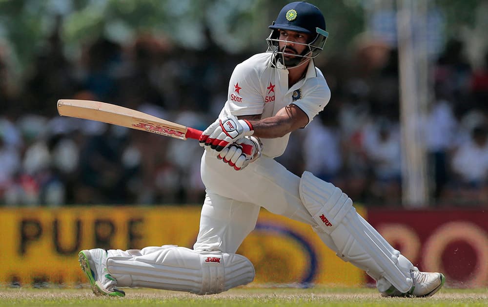 Shikar Dhawan plays a shot during the second day of their first test cricket match against Sri Lanka in Galle, Sri Lanka.