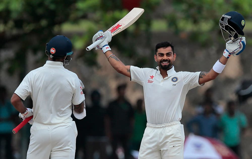 Virat Kohli celebrates scoring a century during the second day of their first test cricket match against Sri Lanka in Galle, Sri Lanka.