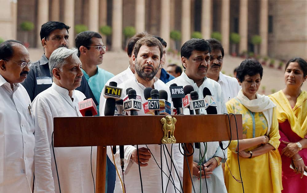 Congress Vice President Rahul Gandhi flanked by other party leaders speaks to the media after meeting President Pranab Mukherjee, at Rashtrapati Bhavan in New Delhi.