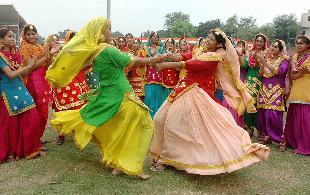 School children perform during the full dress rehearsal for Independence Day celebrations at Guru Nanak Stadium in Amritsar.