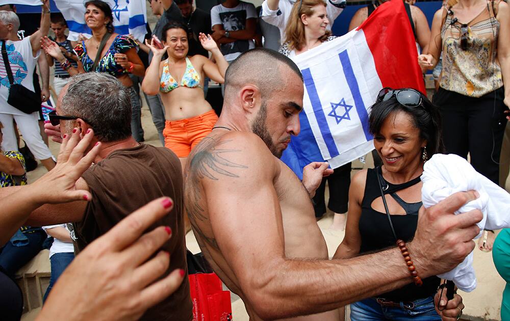 People dance during the Paris Tel Aviv Beach event, on the banks of the Seine River, in Paris, France.