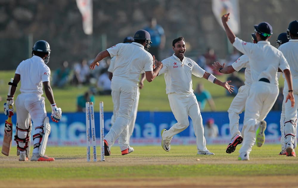 Amit Misra celebrates the wicket of Sri Lankan batsman Kaushal Silva during the second day of the first test cricket match between Sri Lanka and India in Galle, Sri Lanka.