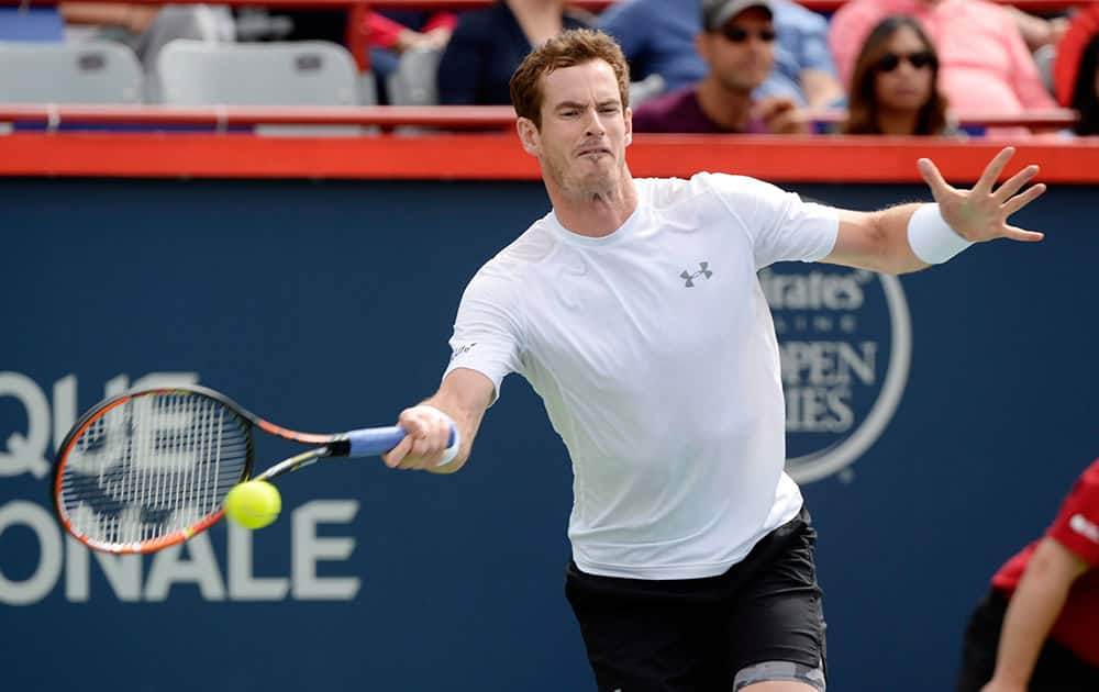 Andy Murray, of Great Britain, hits a return to Gilles Muller, of Luxembourg, during the Rogers Cup men's tennis tournament in Montreal.