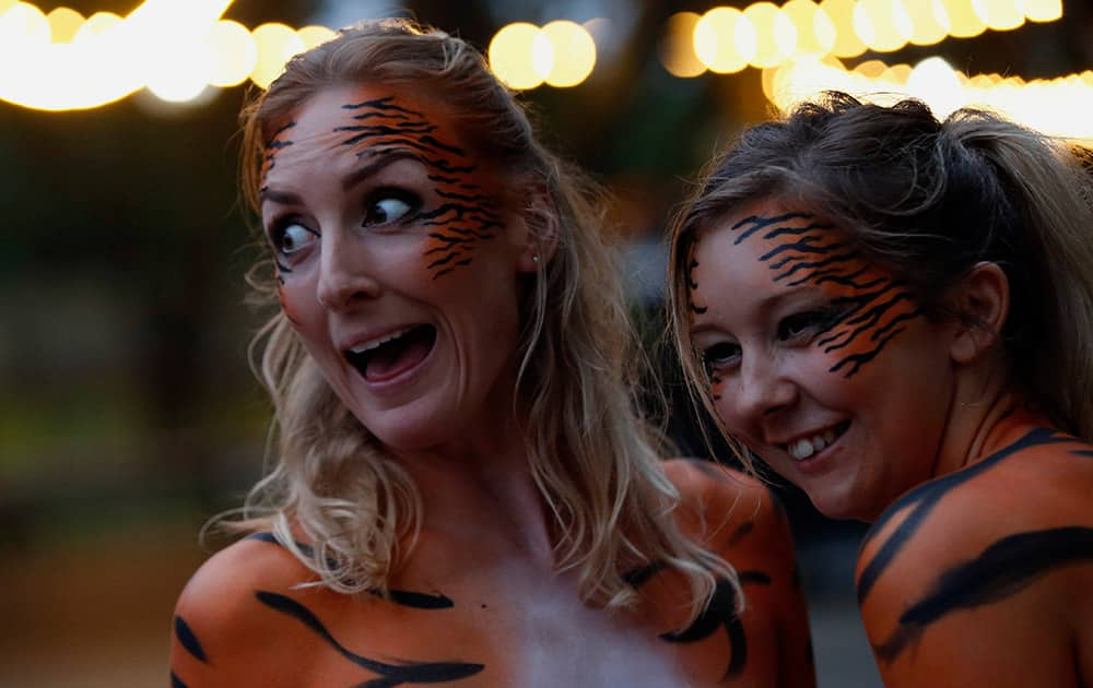 Zoo Keepers form Marwell zoo Clare Sweeten and Amy Wellings pose for the media after they take part in a 'Tiger Streak' at London Zoo where people run around a 300m course in the zoo in the nude to raise money for Tiger conservation projects, in London.