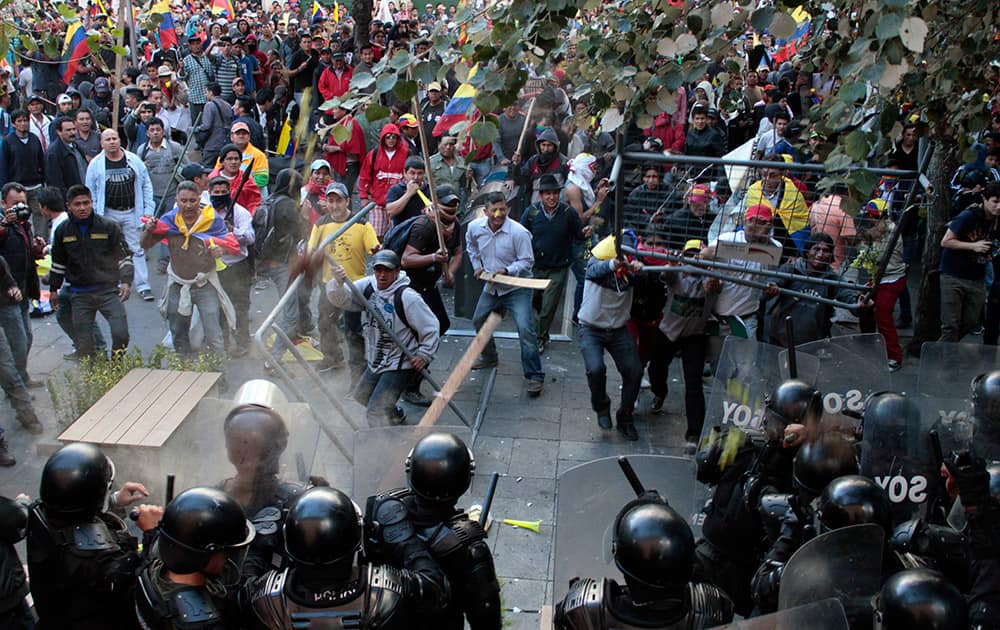 Protesters clash with police near the government palace in Quito, Ecuador.