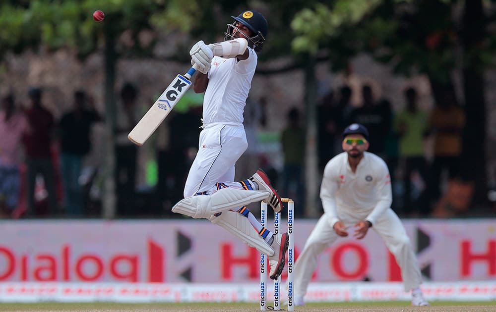 Dhammika Prasad plays a rising delivery before getting out during the third day of the first cricket test match between India and Sri Lanka in Galle, Sri Lanka.
