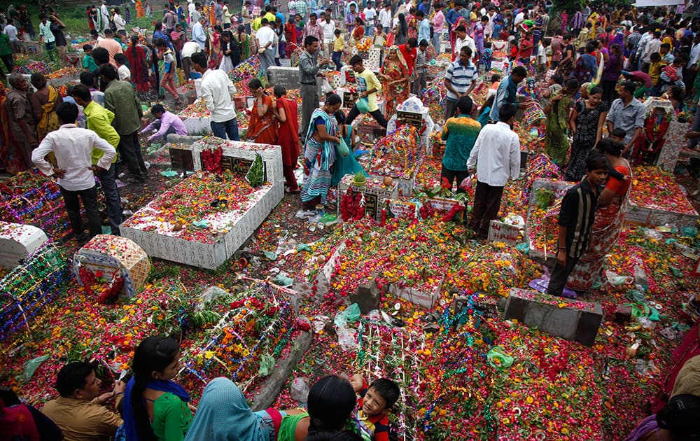 Members of Devipujak tribe gather at a graveyard during Diwaso festival in Ahmadabad. Devipujak tribe members decorate graves, mourn and offer gifts to deceased relatives during this annual festival. 