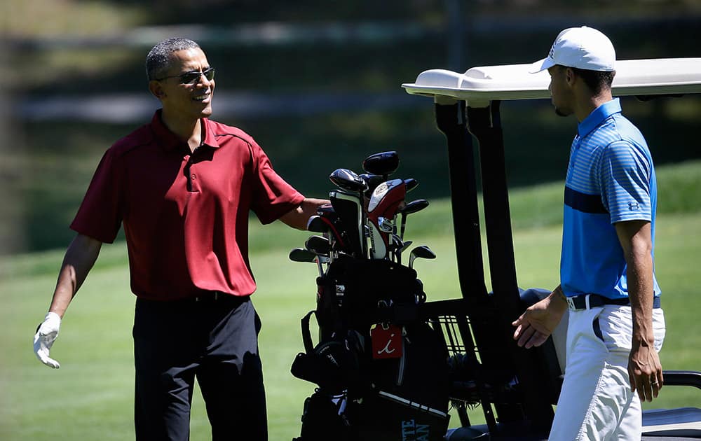 President Barack Obama speaks with NBA basketball player Stephen Curry, of the Golden State Warriors, while golfing, at Farm Neck Golf Club, in Oak Bluffs, Mass., on the island of Martha's Vineyard. The president, first lady Michelle Obama, and daughter Sasha are vacationing on the island.