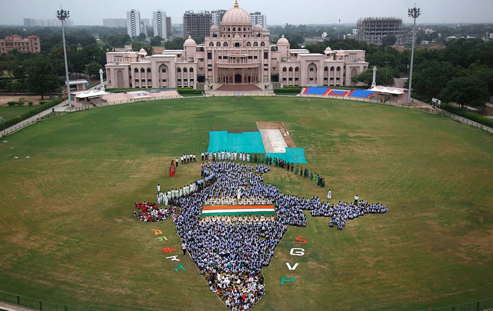 Students and teachers of Swaminarayan Gurukul form the map of India on the eve of Independence Day in Ahmedabad.