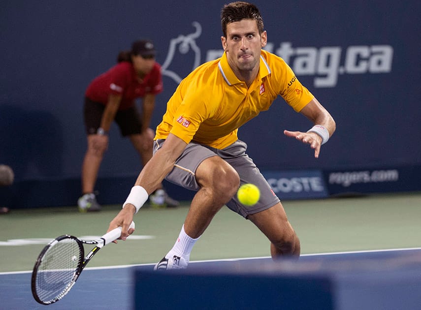 Novak Djokovic of Serbia runs for the ball to return to Ernests Gulbis of Latvia during the quarter finals at the Rogers Cup tennis tournament Friday Aug. 14, 2015 in Montreal.