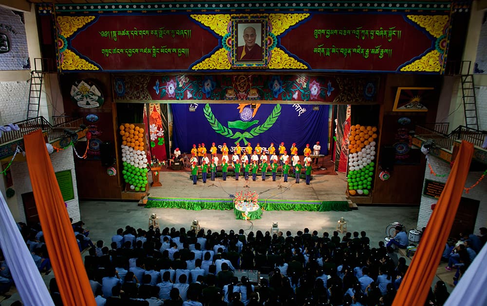Exile Tibetan children dressed in Indian national flag colours sing a song at the Tibetan Children's Village school to mark India’s 69th Independence Day in Dharmsala.