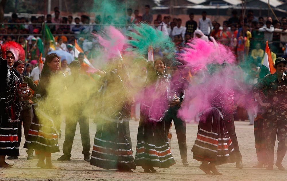 School girls throw colored powder as they perform on the occasion of 69th anniversary of India's independence, in Jammu.