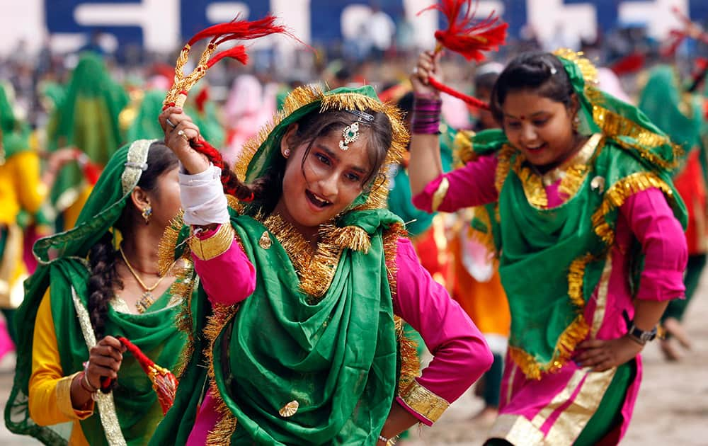 School girls, dressed in traditional attire, perform on the occasion of 69th anniversary of India's independence, in Jammu.