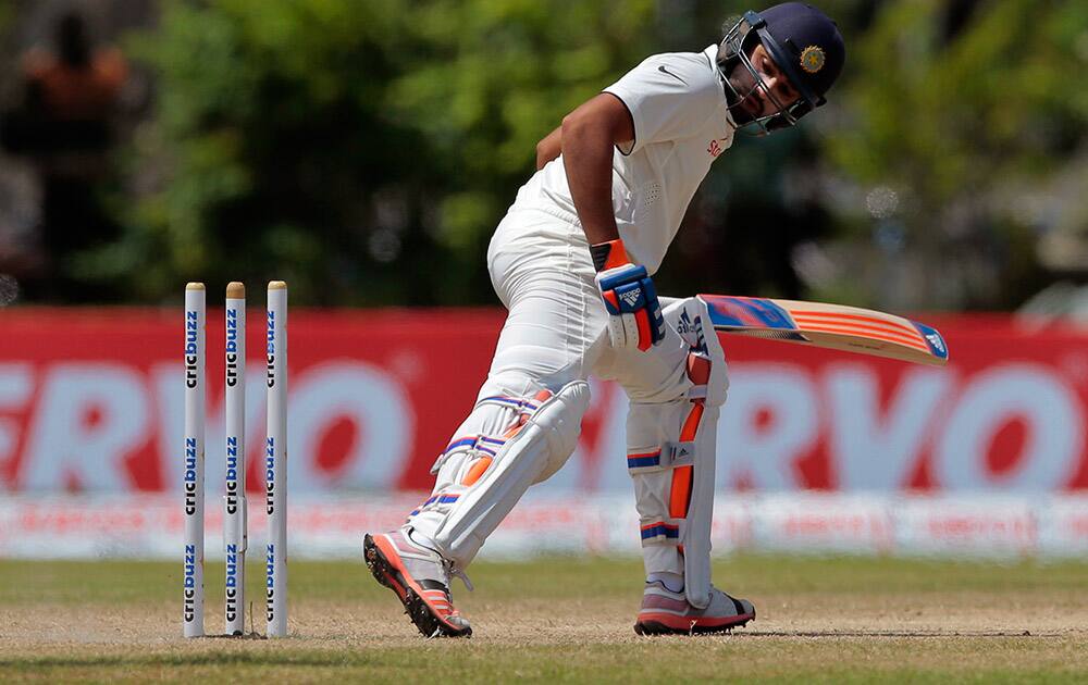 Rohit Sharma looks back at his wicket after being bowled out during the fourth day of their first test cricket match against Sri Lanka in Galle, Sri Lanka.