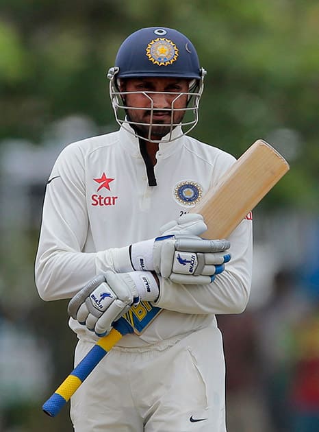 Harbhajan Singh walks back after his dismissal during the fourth day of their first test cricket match against Sri Lanka, in Galle, Sri Lanka. Sri Lanka won by 63 runs.