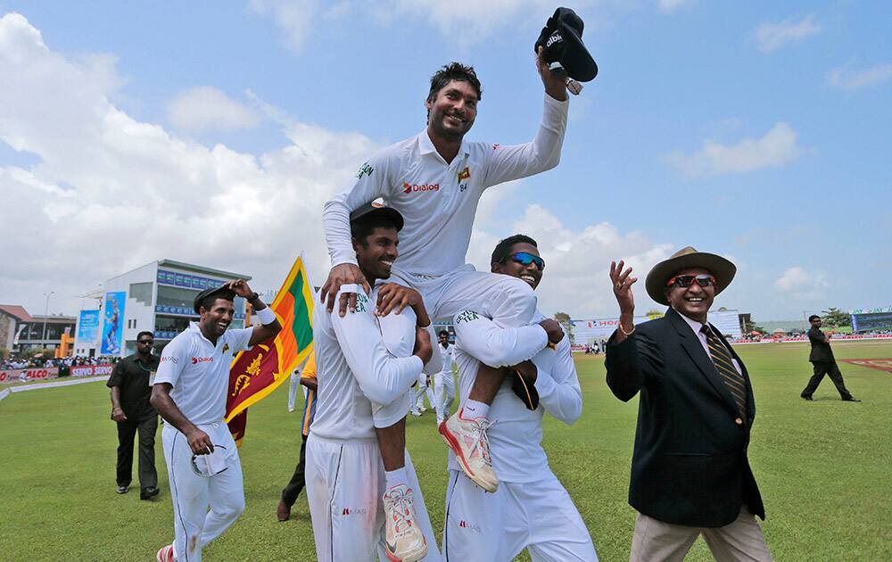 Sri Lankan team members carry Kumar Sangakkara on their shoulders as they walk around the field to celebrate their win over India by 63 runs in their first test cricket match in Galle, Sri Lanka. Sangakkara, the elegant left-hander, is set to sign off from his test career after he plays his second test match against India starting Thursday, Aug. 20, 2015.