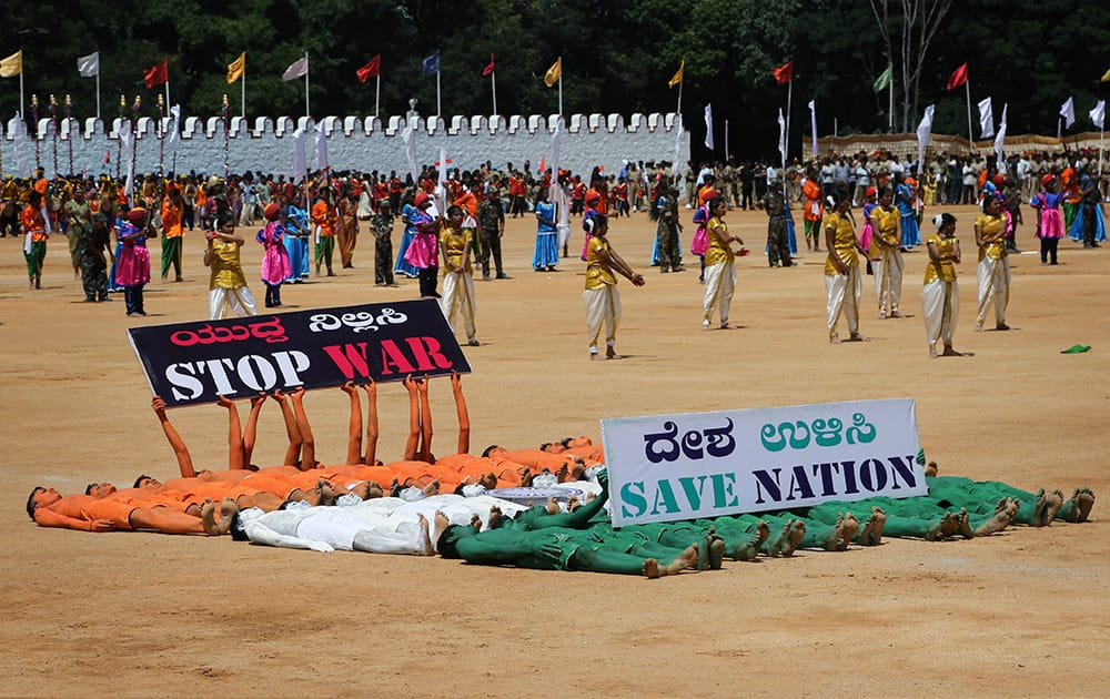 Students hold placards to convey a message as they perform on the occasion of India’s 69th Independence Day in Bangalore.
