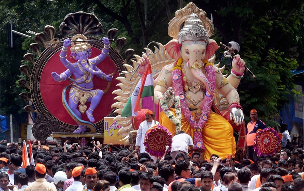 Devotees shift Ganesh idols to the pandals for the upcoming Ganesh Chaturthi festival in Mumbai.