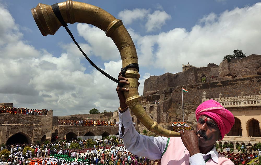 A artist blows a traditional instrument during the 69th Independence Day celebrations at Golconda Fort in Hyderabad.