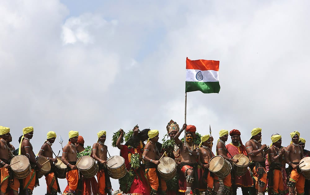 Artist hold the national flag during the 69th Independence Day celebrations at Golconda Fort in Hyderabad.