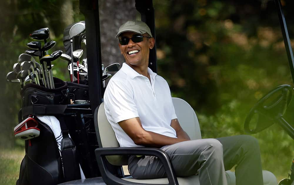 President Barack Obama smiles as he sits in a cart while golfing at Farm Neck Golf Club, in Oak Bluffs, Mass., on the island of Martha's Vineyard. 