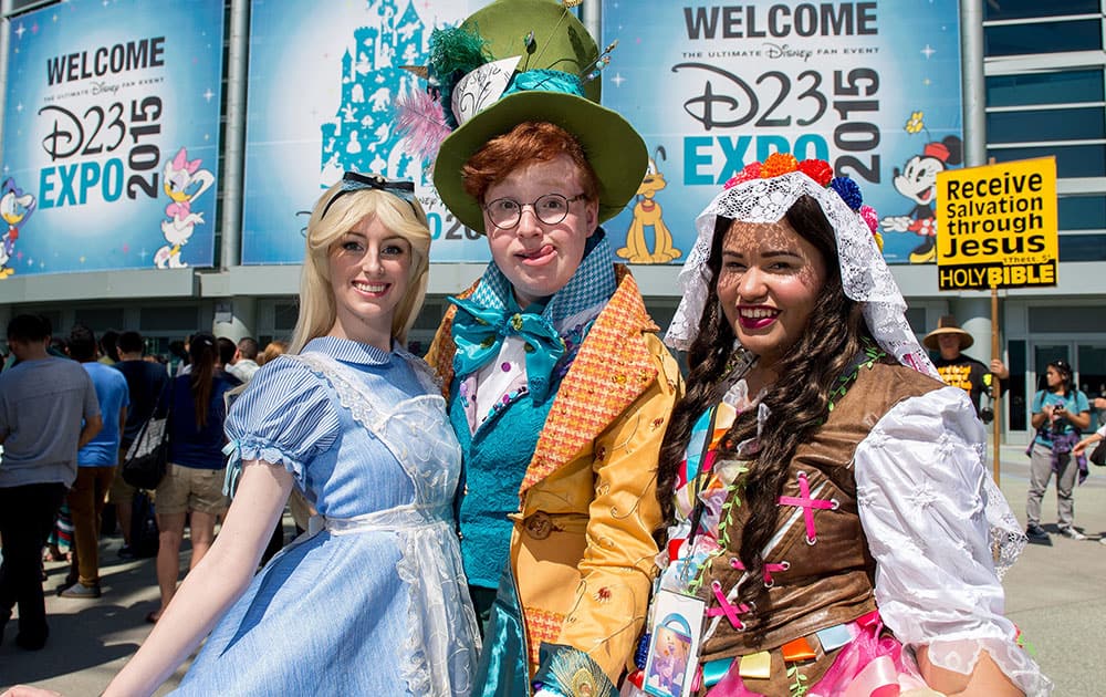 Chelsea Rebecca, David McCarthy, and Andie Vazquez, from left, arrive at the second day of D23 EXPO 2015 at the Anaheim Convention Center in Anaheim, Calif.,