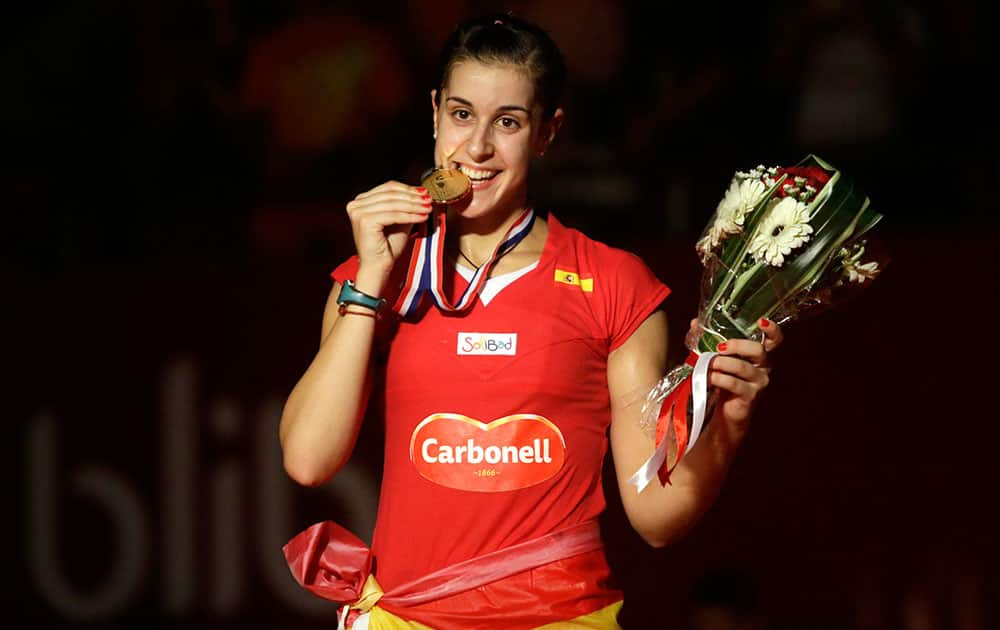 Spain's Carolina Marin poses with her gold medal for a photo during an award ceremony after defeating India's Saina Nehwal in their women's singles final match at the Badminton World Federation championships at Istora Stadium in Jakarta, Indonesia.