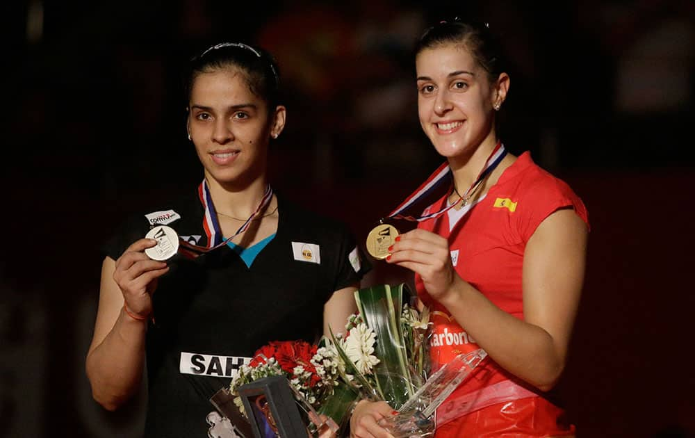 Spains Carolina Marin and Indias Saina Nehwal pose with their medals during an award ceremony after their womens singles final match at the Badminton World Federation championships at Istora Stadium in Jakarta, Indonesia.