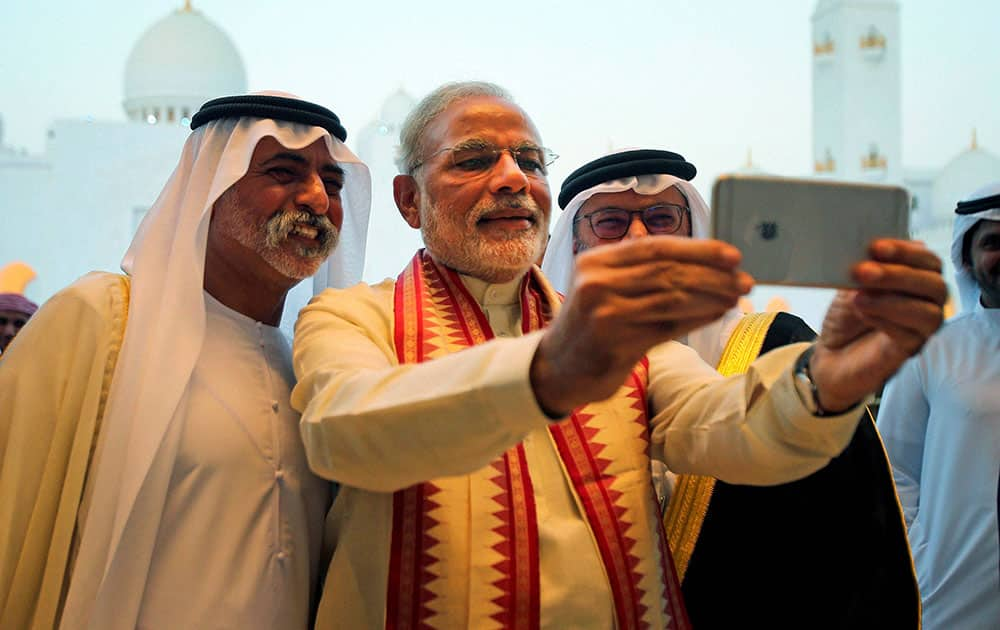 Prime Minister Narendra Modi takes a selfie with Sheikh Hamdan bin Mubarak Al Nahyan, UAE Minister of Higher Education and Scientific Research, during his visit to the Sheikh Zayed Grand Mosque on the first day of his two-day visit to the UAE, in Abu Dhabi, United Arab Emirates.